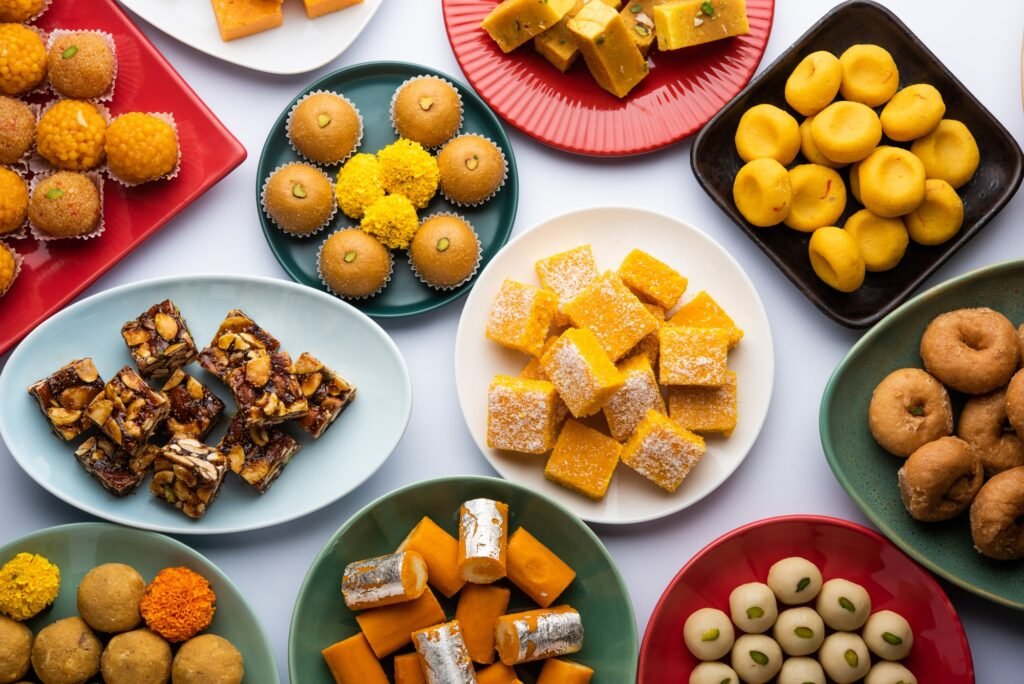 Group of Indian assorted sweets or mithai with diya