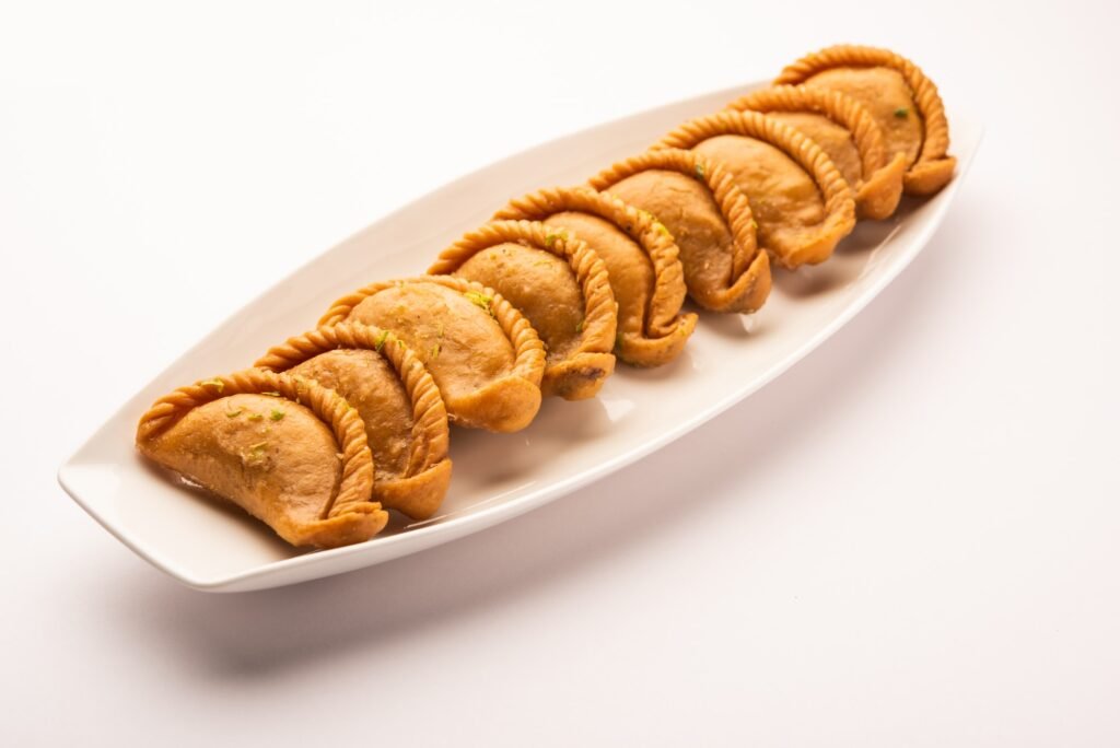 Indian Hili festival sweet Gujiya or Gujia or karanji in a plate